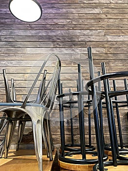 Chairs on a table inside a restaurant. Closed pubs during COVID-19 coronavirus pandemic. Restrictions around the world.