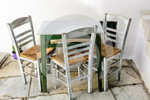 Chairs and table outside a tavern on a Cycladic island