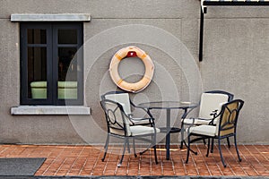 Chairs and table place nearly swimming pool.