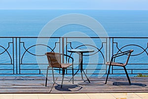 chairs and table on terassa by sea
