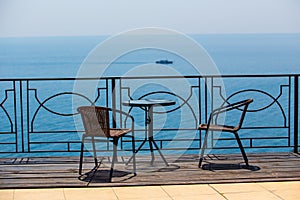 chairs and table on terassa by sea