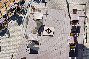 Chairs and tables in a cozy street cafe. Top view