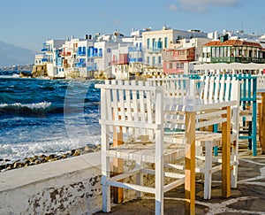 Chairs with tables in Greek tavern in Little Venice part of Mykonos town, Mykonos, Greece
