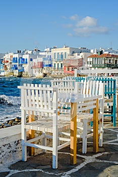 Chairs with tables in Greek tavern in Little Venice part of Mykonos town, Mykonos, Greece