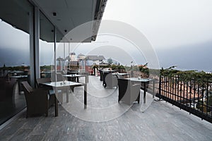 Chairs and tables at outdoor restaurant in luxury hotel