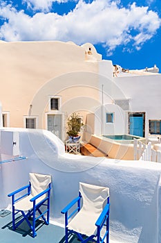 Chairs on terrace of typical Greek houses in Oia village on Santorini island, Greece