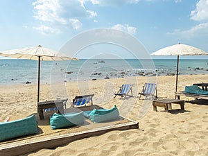 Chairs and umbrellas on beach in sunny day