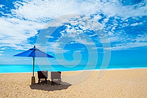 Chairs and umbrellas on a beautiful beach and blue sky