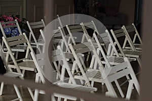 Chairs. White chairs. Wood. Hall. Chairs for the wedding. Decorations.