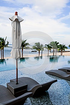 Chaise longue at the pool in tropical resort