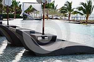 Chaise longue at the pool in tropical resort