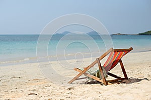 Chaise lounge on the tropical beach at sunny summer day.