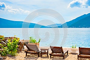 Chaise lounges on the beach in Kotor bay, Montenegro