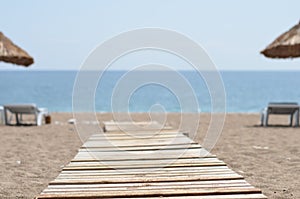 chaise lounges on beach ocean