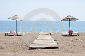 Chaise lounges on beach ocean