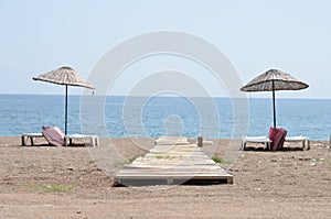 Chaise lounges on beach ocean