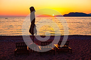 Chaise lounges on the beach in the twilight