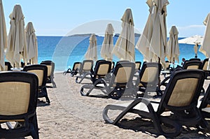 Chaise lounges on ocean beach
