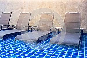 Chaise lounges in swimming pool