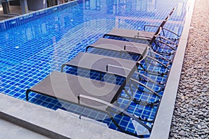 Chaise lounges in swimming pool