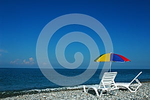 Chaise lounges and umbrella on a beach