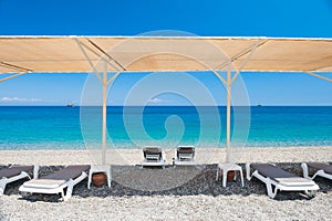 Chaise lounges under the tent on the beach