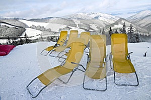 Chaise lounges in winter resort