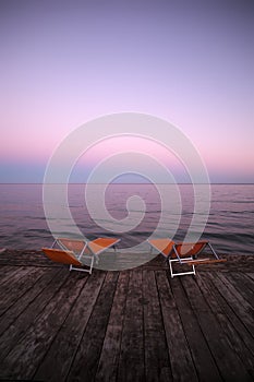 Chaise lounges on wooden pier