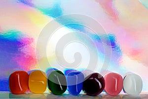 Chakra Healing Stones header rainbow coloured graduated banner copy space above. Top view