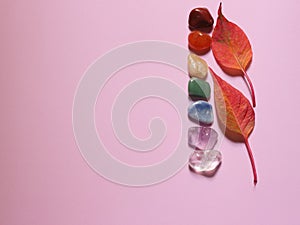 Chakra healing stones on pink millennial background