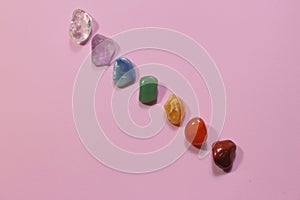 Chakra healing stones on pink millennial background