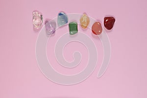 Chakra healing stones on pink millennial background