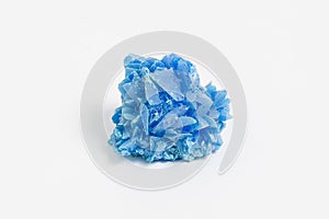 Chalcanthite ore on white background, also known as copper sulphate is a richly colored blue/green water-soluble sulfate mineral