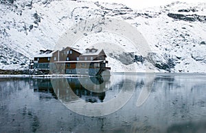 Chalet on Balea Lake and surrounded by mountains photo