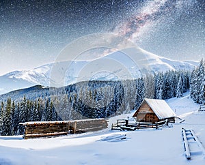 Chalets in the mountains at night under the stars.