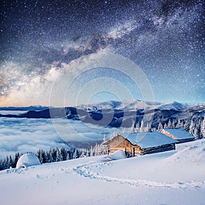 Chalets in the mountains at night under the stars. Courtesy of NASA. Magic event in frosty day. In anticipation th