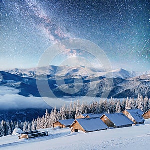 Chalets in the mountains at night under the stars. Courtesy of NASA. Magic event in frosty day. In anticipation th