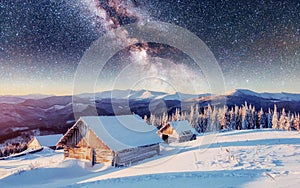 Chalets in the mountains at night under the stars. Magic event in frosty day. In anticipation of the holiday