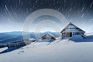 Chalets in the mountains at night under the stars. Magic event in frosty day. In anticipation of the holiday. Dramatic