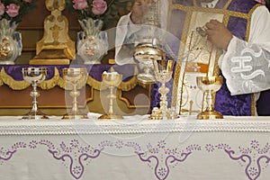 Chalice and ambula being incensed - consecration of bread and wafer wine photo