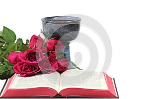 Chalice, bible and roses on white background