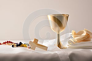 Chalice and consecrated host on table white isolated background photo