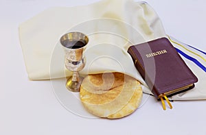 Chalice with red wine bread and Holy Bible