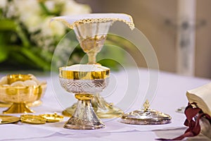 Chalice with wine, blood of christ, and pyx with bread, body of christ, ready for the communion of the faithful