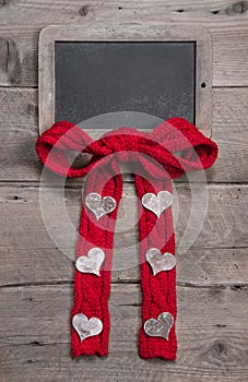 Chalk board for message with red knitted bow and hearts