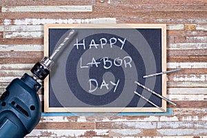 Chalk board with text HAPPY LABOR DAY with electronics drills on