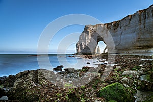 Chalk cliffs of Etretat with the natural arch called Manneporte the natural arch Porte d`Aval and the stone needle called L`