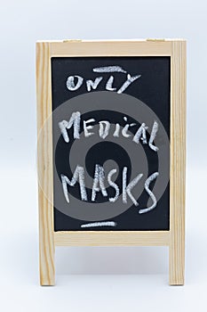 Chalk-described chalk board with the words only medical masks at Covid-19 times and as a corona measure