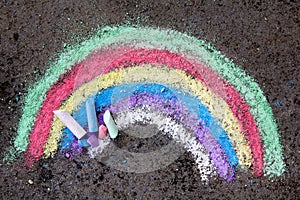 Chalk drawing on asphalt: colorful rainbow