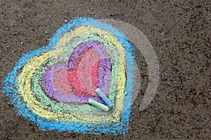 Chalk drawing: colorful hearts on asphalt
